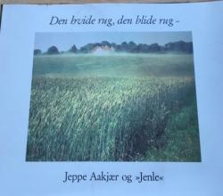 Billede af bogen Den hvide rug, den blide dug, Jeppe Aakjær og Jenle